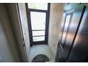 View of the front door showing a black screen door and decorative welcome mat at 10255 Cody Ln, Orlando, FL 32825