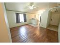 Open floorplan living room featuring hardwood floors that lead to the kitchen at 10255 Cody Ln, Orlando, FL 32825