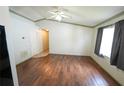 This is an empty living room featuring neutral tones, a ceiling fan, and hardwood floors at 10255 Cody Ln, Orlando, FL 32825