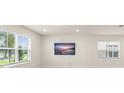 Well-lit living room featuring large windows and contemporary decor at 10959 Vesper Aly, Orlando, FL 32829