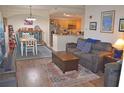 Open concept living room with wood floors, a dining area, and kitchen at 12212 Wild Iris Way # 106, Orlando, FL 32837