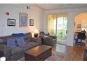 Comfortable living room with a sliding glass door to a screened balcony and an adjacent office nook at 12212 Wild Iris Way # 106, Orlando, FL 32837