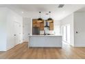 Modern kitchen featuring an island with pendant lighting, wood cabinets, and stainless steel appliances at 1321 Weber St, Orlando, FL 32803