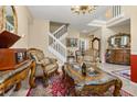 Elegant living room showcases a staircase, tile floors, and classic furniture with ornate detailing at 13609 Sky Blue Ct, Orlando, FL 32828