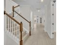 Bright hallway features wood floors, stairs with wood railings, and ample natural light at 13913 Hahn Ln, Orlando, FL 32827