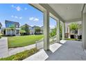 Open porch area offers a scenic view of the lawn and other houses in the neighborhood at 13913 Hahn Ln, Orlando, FL 32827