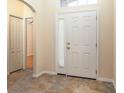 Inviting foyer features beautiful tile flooring, a closet, and a view into the adjoining room at 14155 Portrush Dr, Orlando, FL 32828