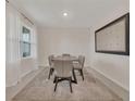 Cozy dining room featuring a modern table, soft lighting, neutral décor, and a large decorative mirror at 1541 Tali Ln, Mount Dora, FL 32757