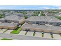 An aerial view of townhomes, showcasing garages and landscaping at 15651 Kinnow Mandarin Ln, Winter Garden, FL 34787
