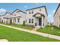 Inviting two-story home with a well-maintained lawn and charming front porch, perfect for a growing Gathering at 16460 Silver Brook Way, Winter Garden, FL 34787