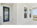 Covered front porch featuring a glass paneled front door and views of the outdoors at 16544 Silver Brook Way, Winter Garden, FL 34787