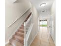 Hallway with stairs, tile floor, and view to the outside at 1774 Peterson Pl, Sanford, FL 32773