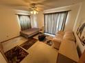 This bedroom offers a ceiling fan, a twin sized bed and a comfy sofa at 2120 Lakebreeze Way, Deltona, FL 32738