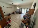 Spacious living room with lots of light, laminate flooring and sliding glass doors to pool at 2120 Lakebreeze Way, Deltona, FL 32738