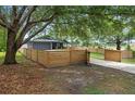 Beautiful home showcasing mature trees and a fenced yard, offering a serene and private setting at 2415 S Oak Ave, Sanford, FL 32771