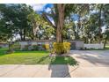 Traditional gray home with large tree in front yard at 3049 Condel Drive, Orlando, FL 32812