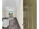 Bright and airy open floorplan with wood-look floors and sliding glass doors leading to the patio at 31830 Sybil Ave, Sorrento, FL 32776
