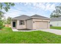 Charming single-story home featuring a two-car garage, well-maintained lawn, and neutral exterior paint at 31836 Sybil Ave, Sorrento, FL 32776