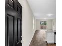 Bright, open-concept living space with modern finishes, hardwood floors, and a sliding glass door at 31836 Sybil Ave, Sorrento, FL 32776