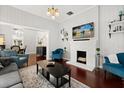 Bright living room featuring hardwood floors, a fireplace, stylish furniture, and an open layout at 40 W Smith St, Winter Garden, FL 34787