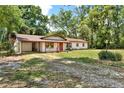 Cozy single-story home with a covered parking area, a well-manicured lawn, and an inviting curb appeal at 474 Overstreet Ave, Longwood, FL 32750