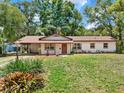 Well-maintained single-story home with mature landscaping, featuring a covered parking area at 474 Overstreet Ave, Longwood, FL 32750