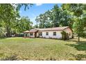 A charming single-story home set back on a spacious lot with mature trees and a well-kept lawn at 474 Overstreet Ave, Longwood, FL 32750