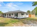 Well maintained home with white painted brick, dark shutters, dark roof and a manicured lawn at 4804 Oakbrooke Pl, Orlando, FL 32812