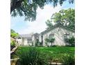 Inviting single-story home with green lawn and shade trees, providing a beautiful view at 5005 Mill Stream Rd, Ocoee, FL 34761