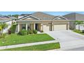 Charming single-Gathering home with well-manicured lawn, a two-car garage, and inviting curb appeal at 588 Hitch Loop, St Cloud, FL 34769