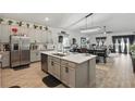 Spacious kitchen features stainless steel appliances, large island, and modern cabinetry at 588 Hitch Loop, St Cloud, FL 34769