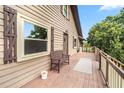 Relaxing covered deck featuring outdoor seating, smooth wood floors, and scenic views at 6375 Topsy Trl, St Cloud, FL 34771
