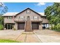 Inviting elevated home featuring covered parking, charming balconies, and a grand staircase at 6375 Topsy Trl, St Cloud, FL 34771