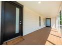 Welcoming front porch featuring a stylish entrance door and ample space for outdoor decor, creating a warm ambiance at 712 Maryland Ave, St Cloud, FL 34769
