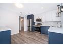 Updated kitchen with stainless steel appliances, white subway tile backsplash, and stylish two-tone cabinetry at 713 Coach Light Dr, Fern Park, FL 32730