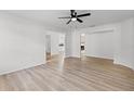 Spacious living room with light wood-look flooring, neutral paint, and open layout at 717 Pine Ter, Altamonte Springs, FL 32714