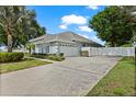 Long driveway leads to a two-car garage with landscaped garden beds along the side of this home at 7978 Sea Pearl Cir, Kissimmee, FL 34747