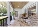 Charming porch with seating area overlooking lush landscape at 940 Lincoln Cir, Winter Park, FL 32789