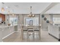 Dining area featuring pendant lighting, modern dining table, and an open-concept layout at 116 Green Branch Blvd, Groveland, FL 34736