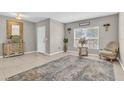 Light-filled foyer featuring neutral walls, decorative mirror, console table and tiled flooring at 116 Green Branch Blvd, Groveland, FL 34736