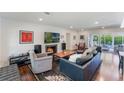 Comfortable living room with a fireplace, plush seating, and a view of the backyard pool through sliding glass doors at 1245 Munster St, Orlando, FL 32803