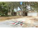 Unique driveway featuring painted compass design leading to home with attached garage at 1405 Paula Dr, Apopka, FL 32703