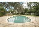 Private backyard pool surrounded by stone pavers, ideal for outdoor enjoyment at 1405 Paula Dr, Apopka, FL 32703