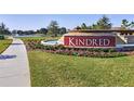 The Kindred community entrance sign is surrounded by landscaping, a pond, and a waterfall at 1684 Badger Creek Rd, Kissimmee, FL 34744