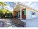 Inviting front porch with brick accents and decorative support beams, nestled in a landscaped yard at 2001 Lily Ct, Sanford, FL 32771