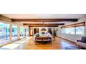 Spacious living room with hardwood floors, exposed beam ceilings, and large windows at 2001 Lily Ct, Sanford, FL 32771
