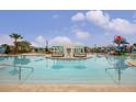 Resort-style pool with lounge chairs, umbrellas, and a splash pad area perfect for Gathering fun at 2030 Majorca Dr, Kissimmee, FL 34747
