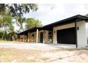 Inviting one-story home with a spacious porch, new exterior paint, and attached garage at 240 W Palmetto Ave, Deland, FL 32720