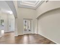 Bright foyer showcasing hardwood floors, high ceilings, decorative arches, and elegant double doors at 2468 Cimmaron Ash Way, Apopka, FL 32703