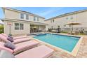 Inviting backyard pool area with lounge chairs and patio furniture, perfect for relaxation at 257 Auburn Ave, Kissimmee, FL 34747